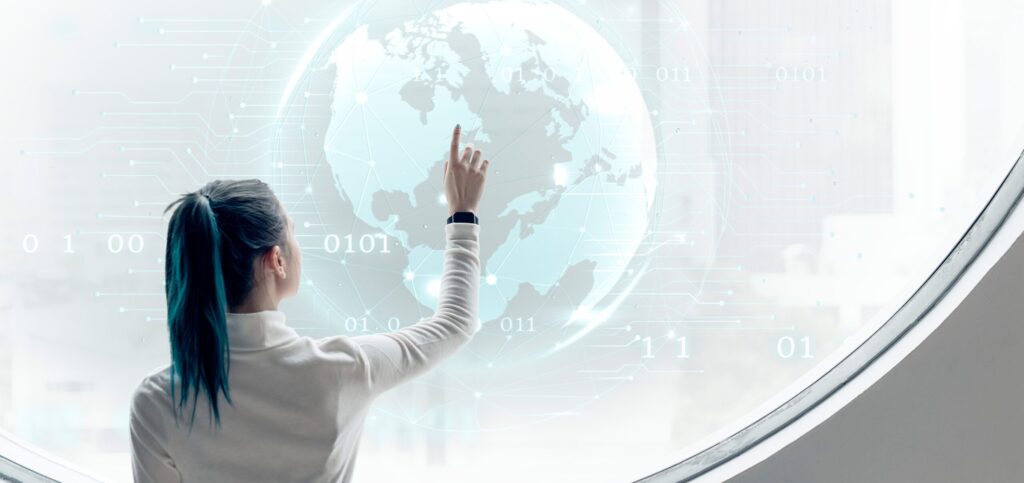 The woman looks at the globe.