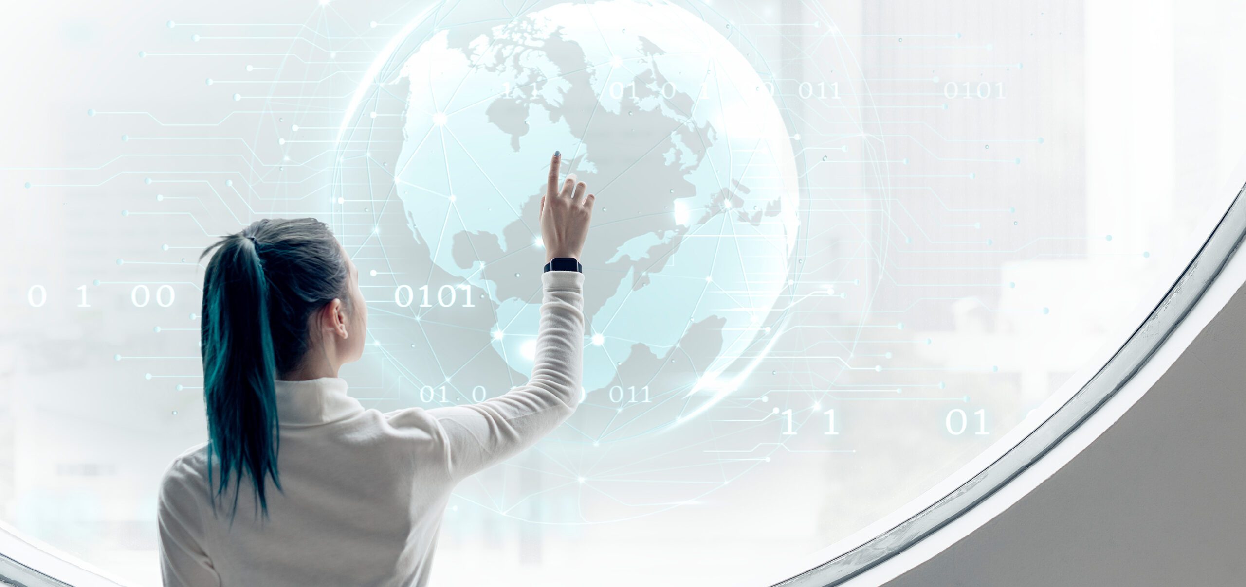 The woman looks at the globe.